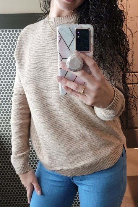 Reviewer in a beige sweater