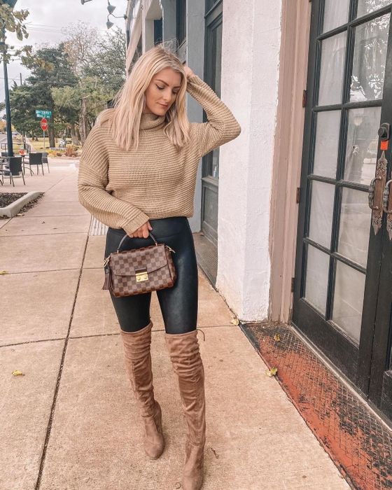 Reviewer photo of a person wearing a light brown sweater, dark jeans, and brown over-the-knee boots
