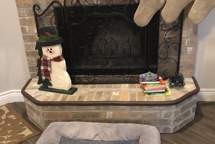 A photo from a reviewer showing the brown tape installed on their brick fireplace