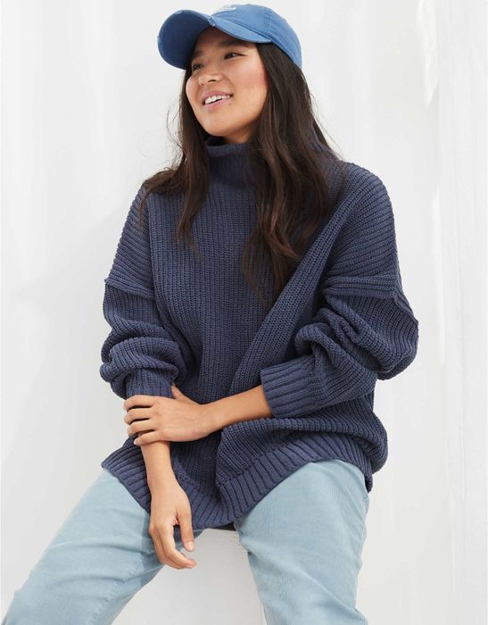 Model in a navy sweater and jeans