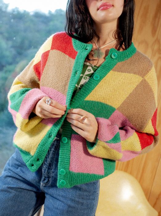 A different model styling the cardigan with jeans