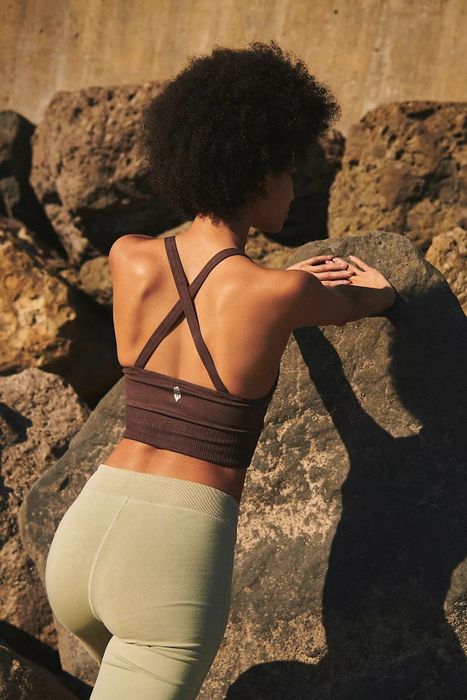 The model is flaunting the brown tank's back design.