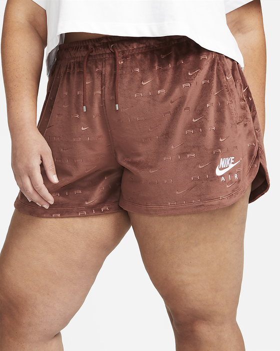 The model is wearing a pair of brown mid-rise shorts.