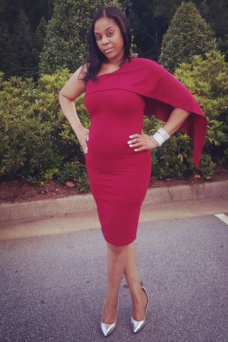 A reviewer in a stunning red off-the-shoulder dress paired with silver heels
