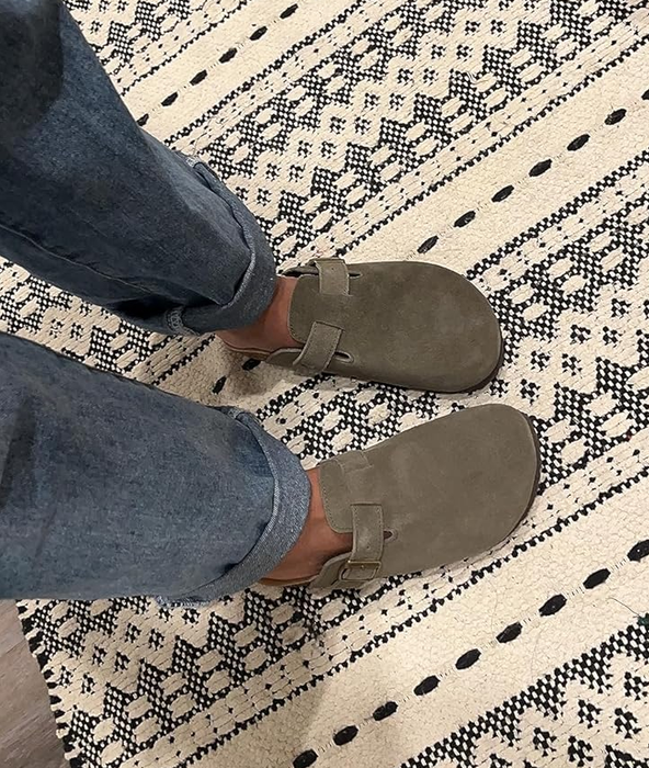 A reviewer wearing the shoes in dark green paired with jeans