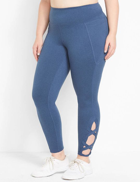 The model is showcasing light blue leggings with a trendy crisscross design at the ankles.