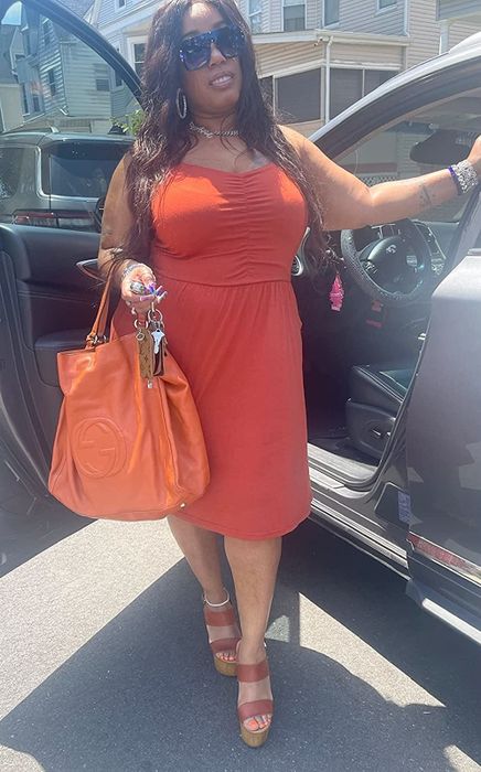 A reviewer wearing the brown dress shares their feedback.