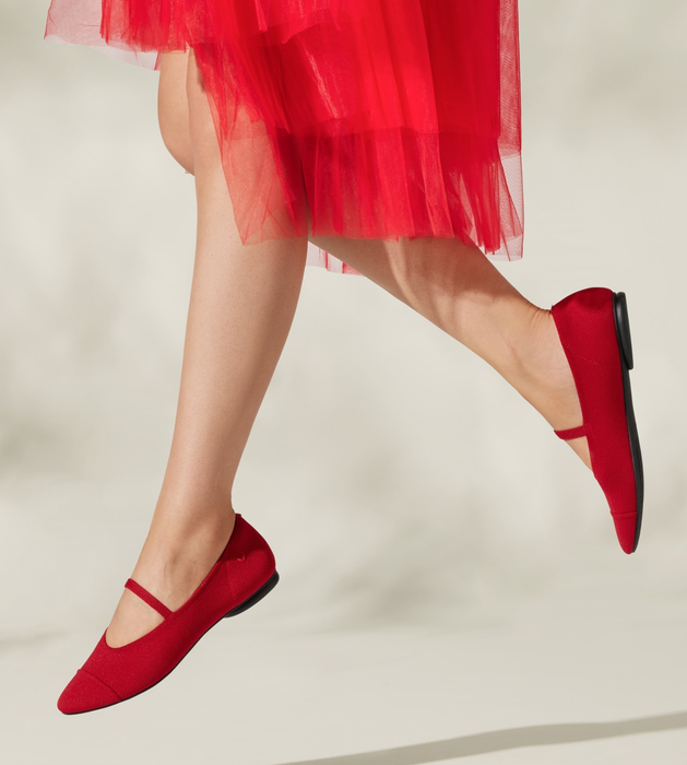 A model rocking the knit Mary Jane flats in red.