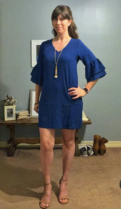 A reviewer showcasing the dress.