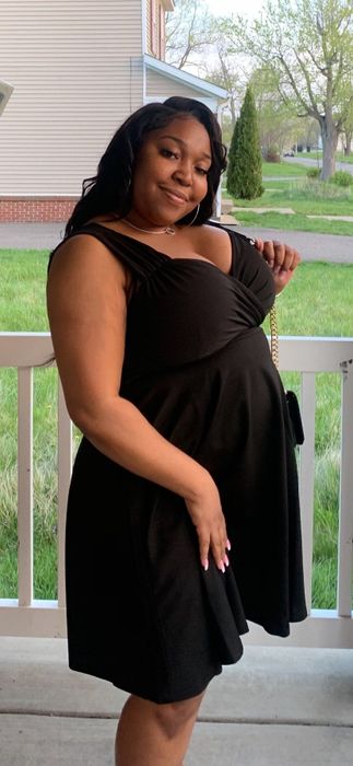 A reviewer rocking the dress in black