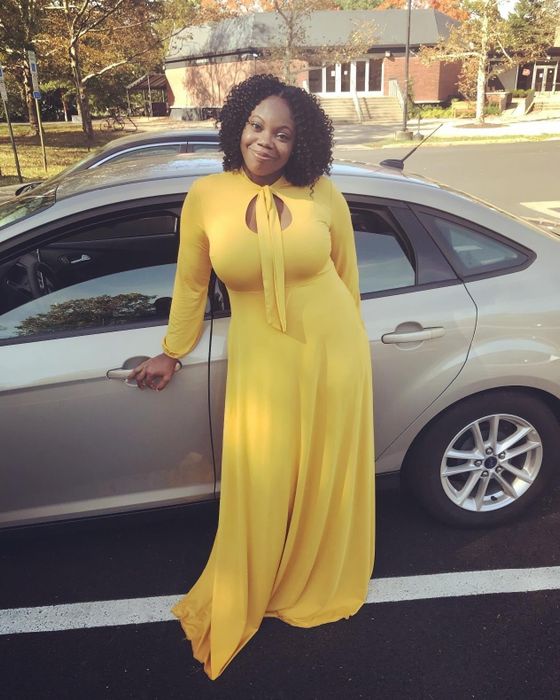 A reviewer is seen wearing a yellow dress.