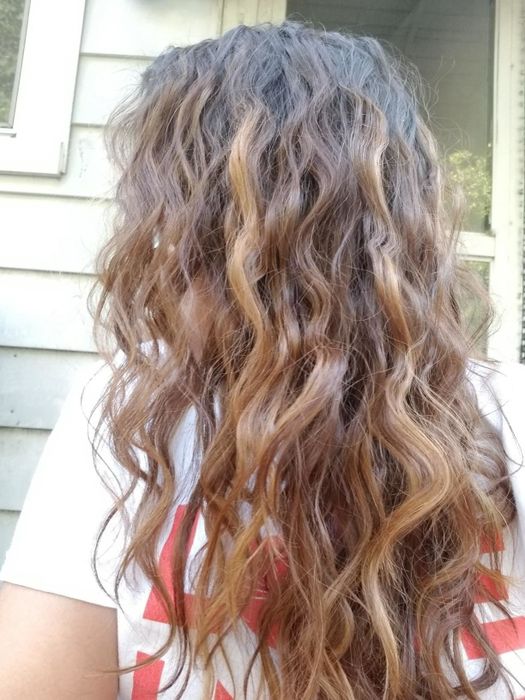 The same reviewer’s hair after using the tool, now with soft, wavy texture.