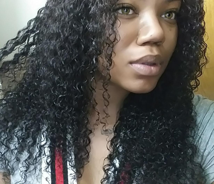 A reviewer showing the perfectly defined curls they've achieved after using the curling gel.