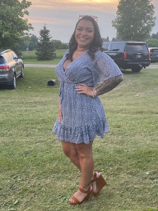 Reviewer sporting a dark blue and white patterned dress