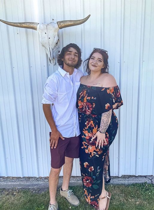 Another reviewer having fun with a friend while wearing the beautiful blue floral print dress.