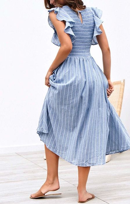 A back view of the model in the smocked-bust midi dress, demonstrating its relaxed yet chic style.