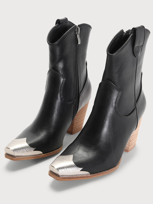 Black western-style ankle boots with wooden block heels and silver pointed toe caps, showcased in a shopping feature