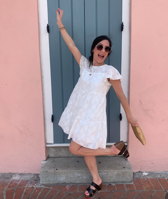 A customer photo featuring them posing in the white version of the dress, capturing its effortless style