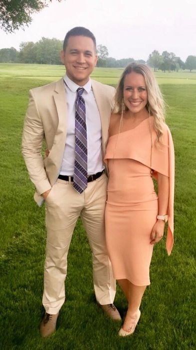 A reviewer showcasing an elegant, off-the-shoulder peach dress