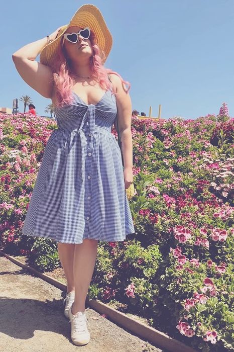 A reviewer flaunting the purple gingham dress
