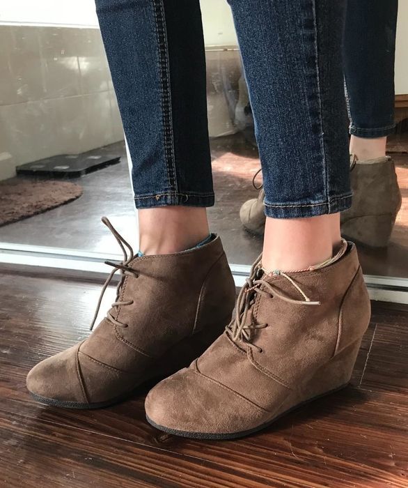 A reviewer paired skinny jeans with brown suede lace-up wedge booties.