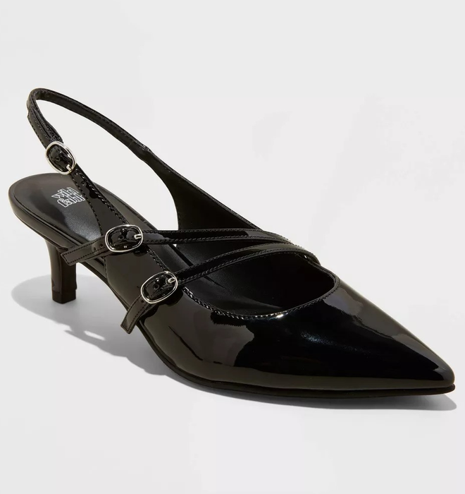 A black patent leather slingback pump with three buckles, a pointed toe, and a modest heel
