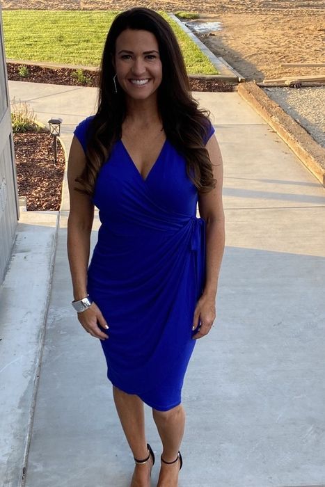 a reviewer showing off the dress in blue