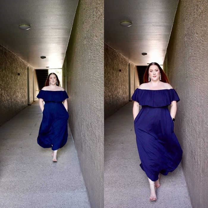 A reviewer wearing a dark blue, off-the-shoulder, floor-length dress