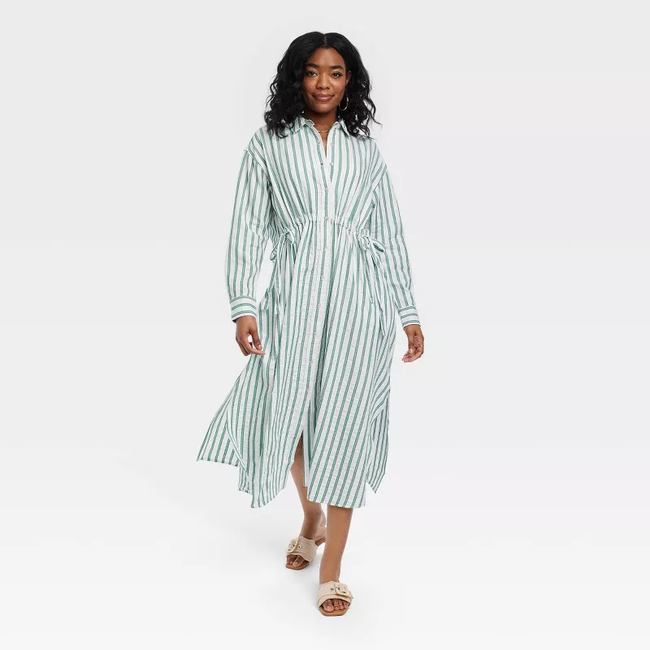 A woman in a casual striped dress and sandals, perfect for a summer wardrobe