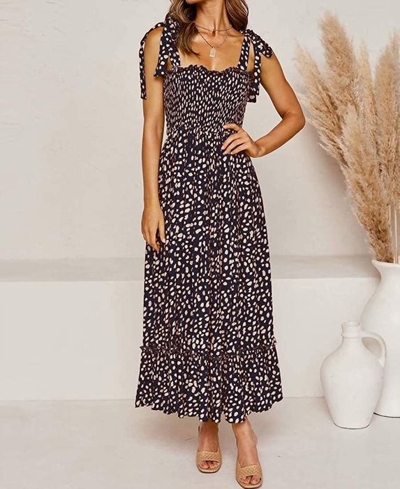 A model showcasing the dress in deep blue, highlighting its elegant design