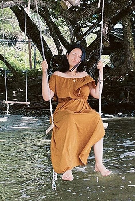 A reviewer in a brown dress shares her thoughts and experience with the outfit.