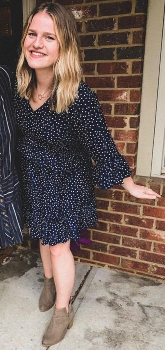 The reviewer is seen in a black dress.