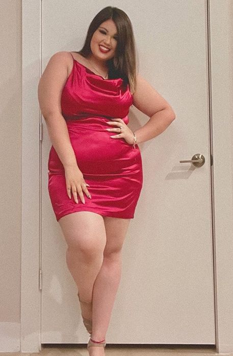 A reviewer in a red dress shares their experience.