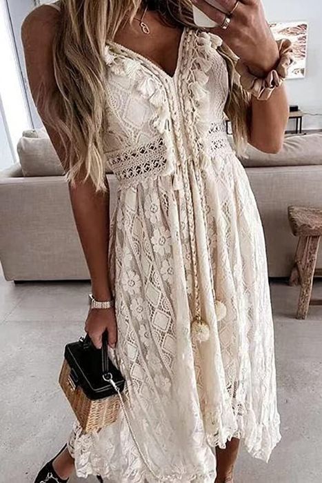 A model is wearing a dress in cream, showcasing its elegant look.