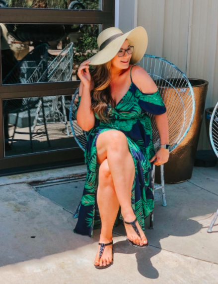 A customer review photo showing them wearing the dress, paired with a stylish summer hat and sandals for a chic and casual look.