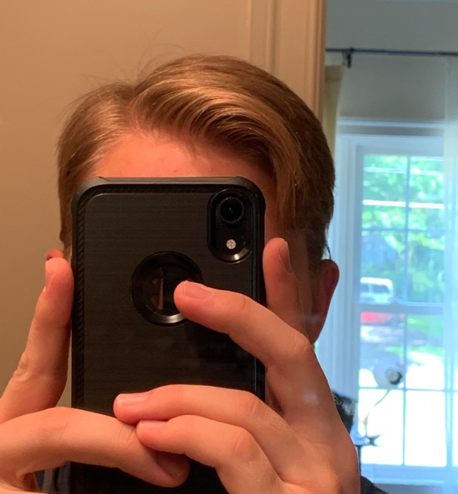 A reviewer with perfectly styled hair, thanks to the product.