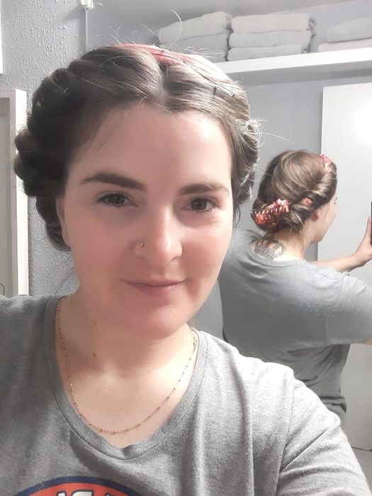 A reviewer using the curler rod in their hair.