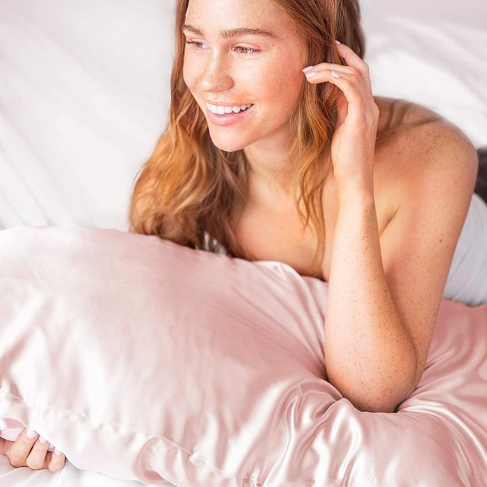 A model resting on the pink pillowcase