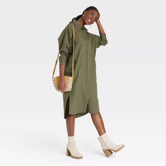 A model in the olive button-down dress