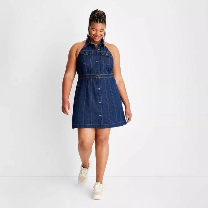 A model in the dark wash halter dress