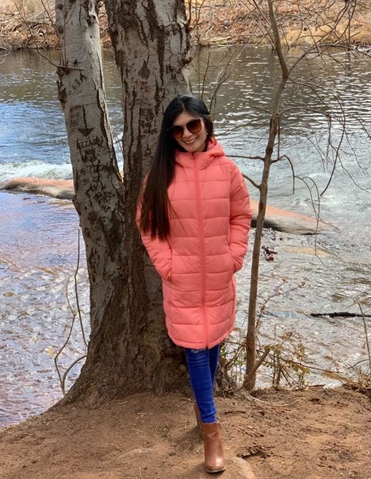 Another reviewer wearing a pink coat.