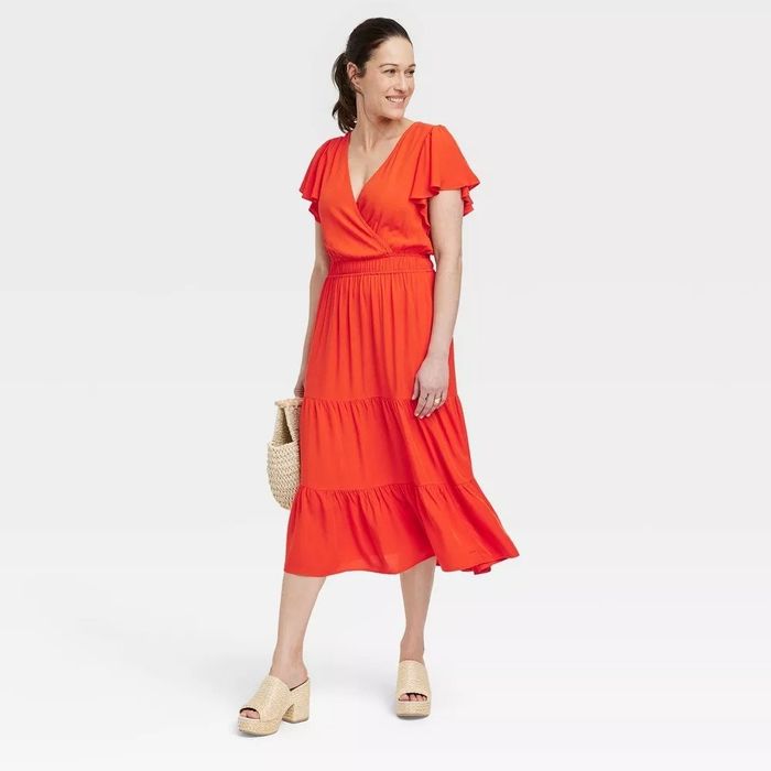 A model wearing a red midi dress