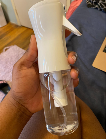 Reviewer holding the mist spray bottle