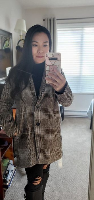Another reviewer shows off the black and white version of the blazer.