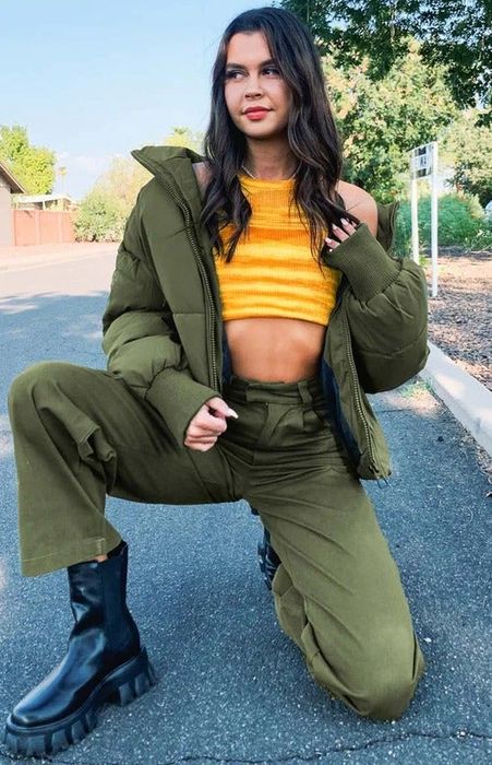 A model crouching while wearing the jacket.