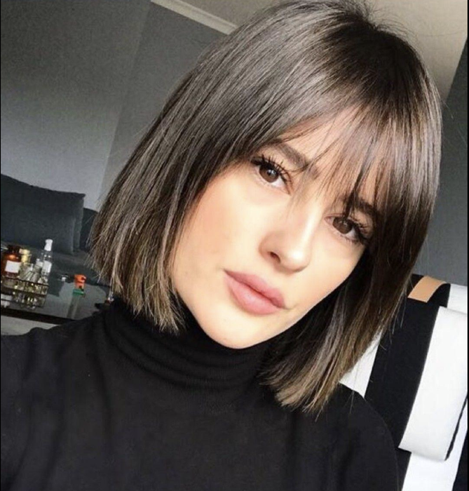 A reviewer with a freshly styled bob and bangs.
