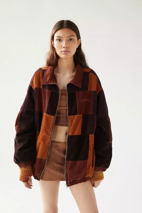 Model wearing the brown jacket paired with a miniskirt.