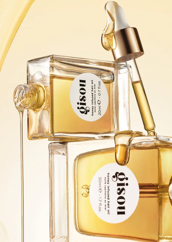 Two bottles stacked on top of each other with oil trickling down them