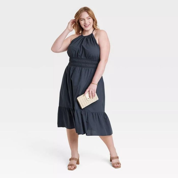 A model in the navy midi dress