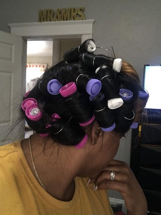 A reviewer with hot rollers in their hair